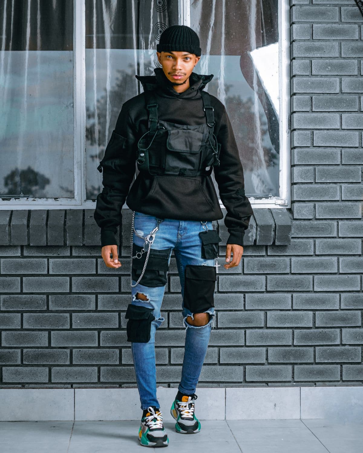 Model in a Threads by RZN jacket against a brick wall