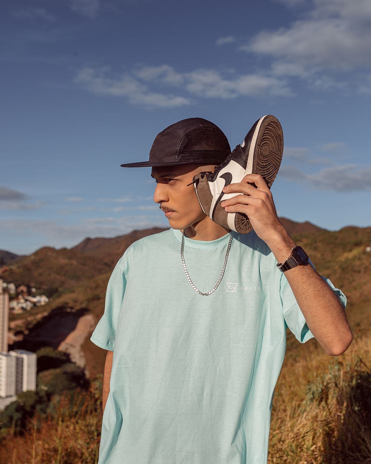 Model in an oversized Threads by RZN tee and cap